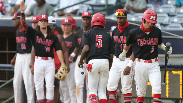 Magee's Tristan Newsome (5) is congratulated by teammates after he scored a run. Booneville and Magee played in game 1 of the MHSAA Class 3A Baseball Championship on Tuesday, June 1, 2021 at Trustmark Park. Photo by Keith Warren