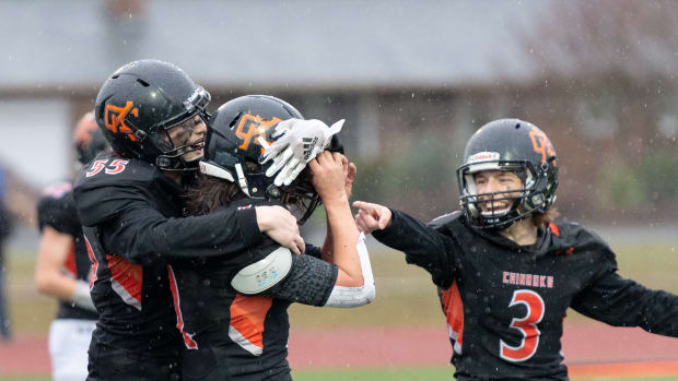 Kalama's Cody Snyder hugs Andrew Schlangen after a 3-yard touchdown run in a 2B State Tournament semifinal football game on Saturday, Nov. 27, 2021, at Tiger Stadium in Centralia. Kalama won 46-30. (Joshua Hart/For ScorebookLive)