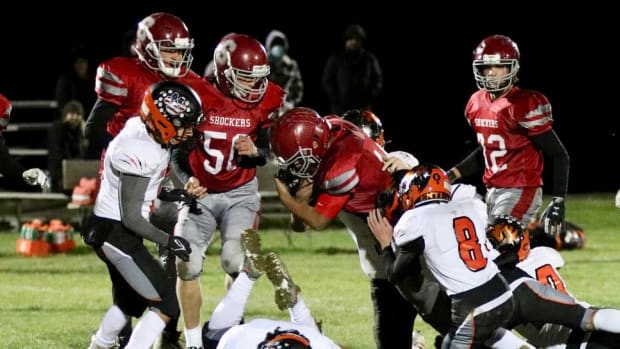 Waterville leading rusher Abraham Diaz is being tackled by a swarm of Entiat defenders in fall of 2021 game.