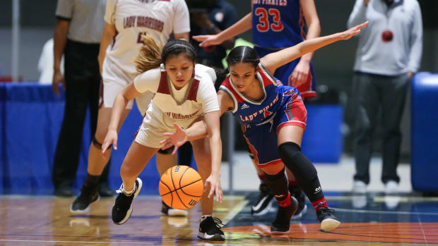 Choctaw Central's Shantashia John (13) and Pass Christian's Rayven Obillo (4) battle for a loose ball. Choctaw Central and Passs Christian played in an MHSAA Class 4A basketball semifinal basketball game at Mississippi Coliseum on Monday, March 1, 2020. Photo by Keith Warren