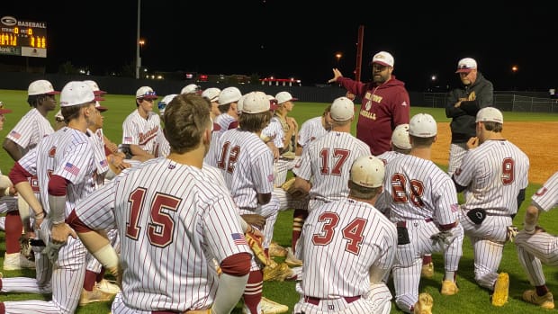 Germantown coach Bryan Hardy talks to his team following the Mavericks' 9-3 win over Madison Central Thursday night in Gluckstadt.