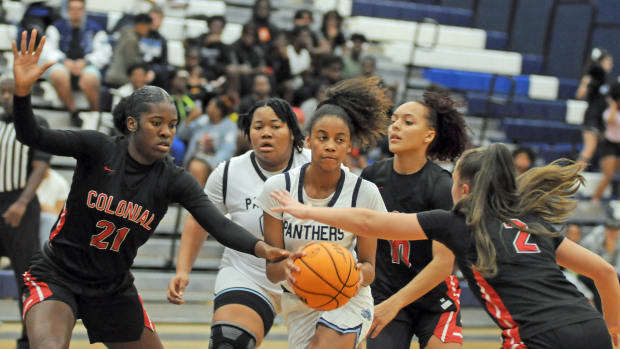 Dr. Phillips freshman guard Kendall Perry drives the lane and draws Colonial defenders Breanne Eccleston (21), Carmen Richardson (10) and Sophya Barreiro (2) during the second quarter of their nondistrict game Wednesday. Perry had 13 points, and Richardson had 12 points.
