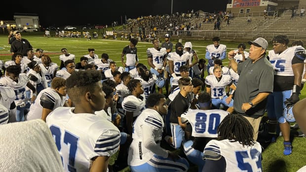 Ridgeland coach Teddy Dyess (right) talks to his team following Friday night's 40-7 win over Jim Hill.