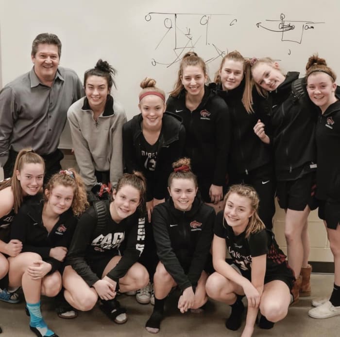 Brad Knowles Sr.  (left), pictured with the Cedarcrest girls basketball team, has posted winning seasons in nine of his 11 years at the helm.