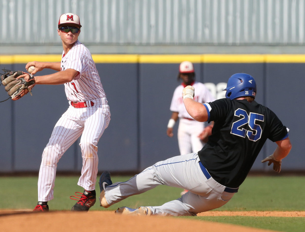 Magee's Kaden Harper (7) throws to first after tagging second base. Booneville's Gage Harrelson (25) slides into second. Booneville and Magee played in game 2 of the MHSAA Class 3A Baseball Championship on Thursday, June 3, 2021 at Trustmark Park. Photo by Keith Warren