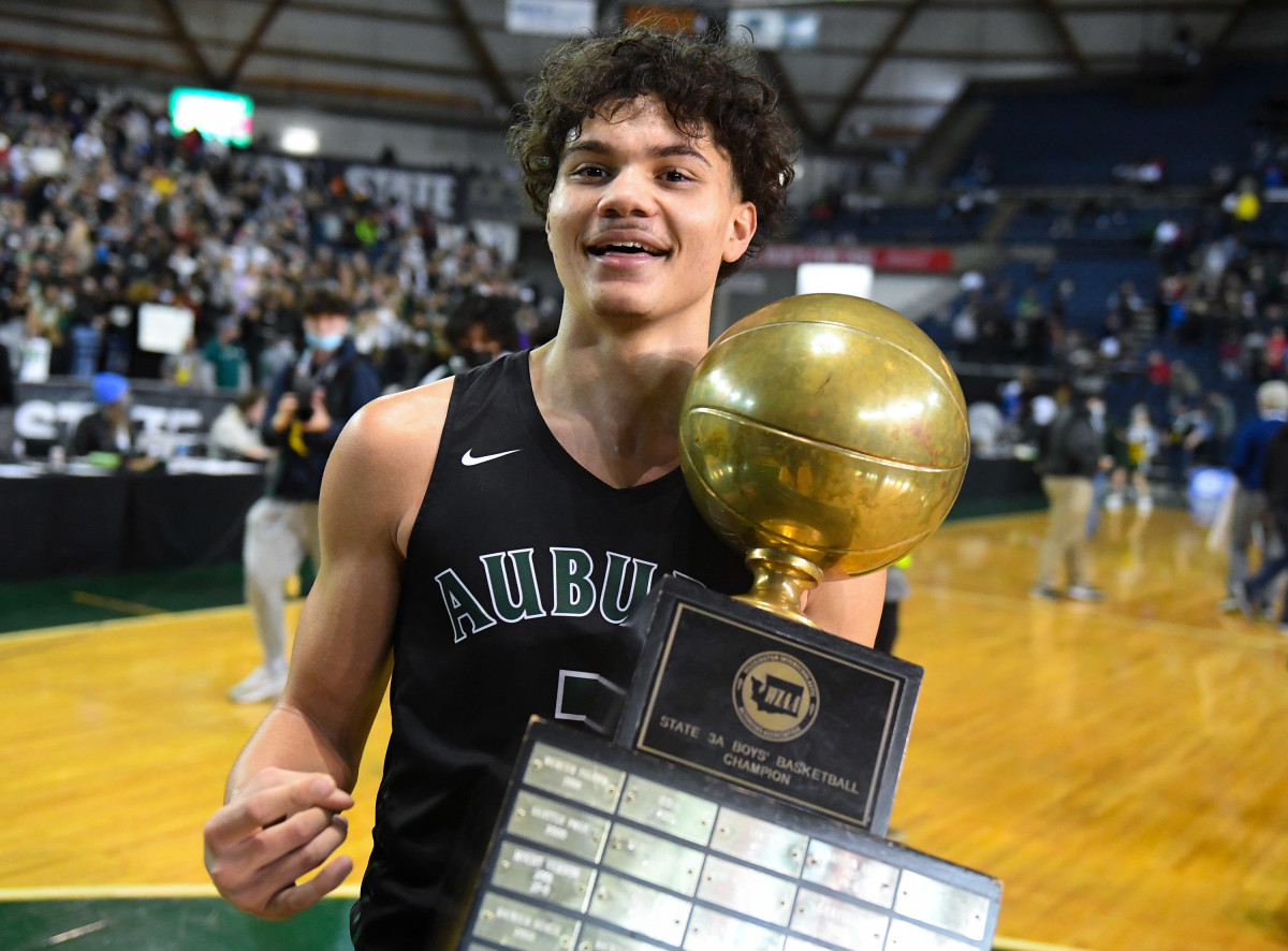 Maleek Arington poses with the Class 3A state championship trophy on March 5.