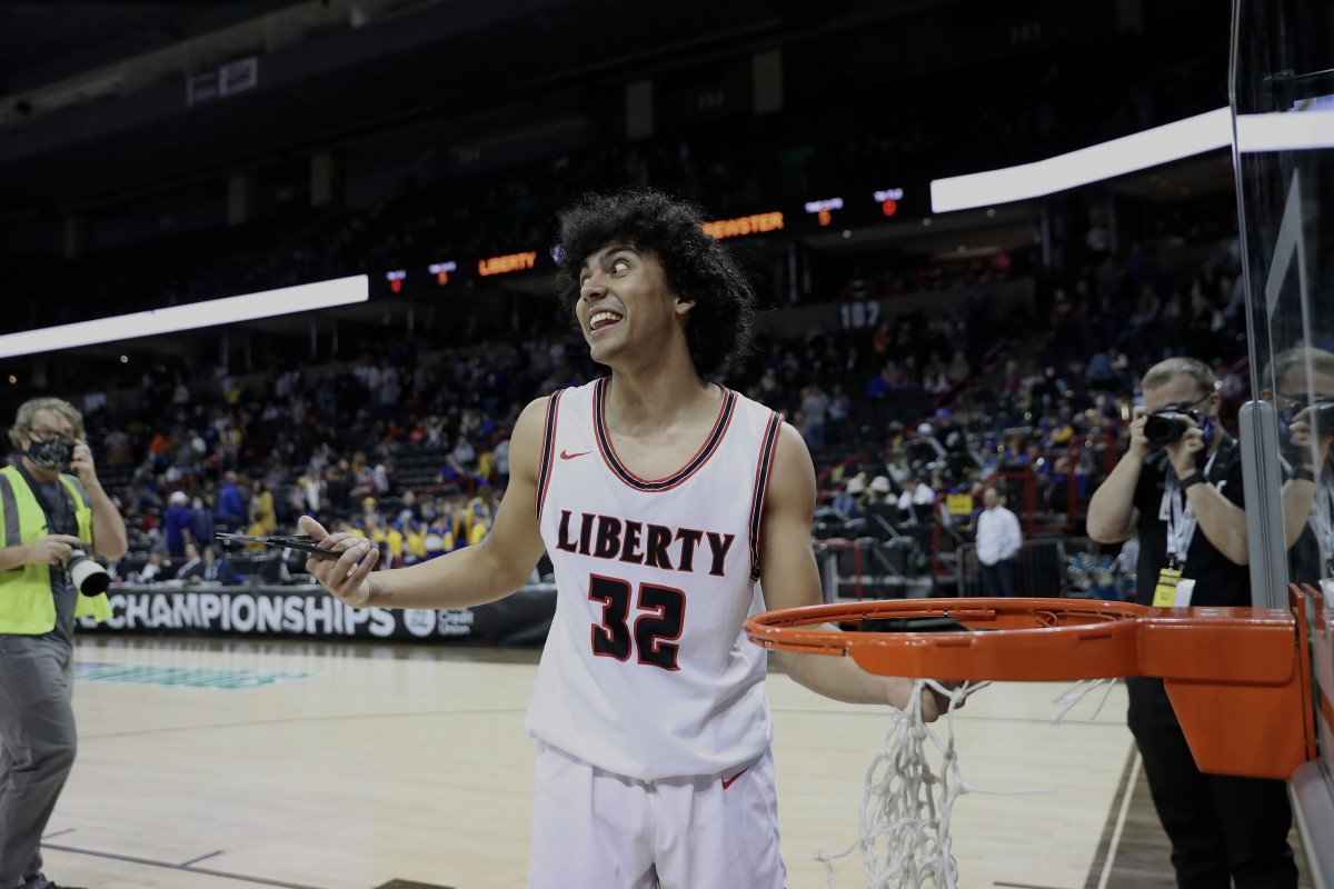 Liberty of Spangle senior guard Tayshawn Colvin smiles as he cuts down the net after leading his team to a 2B state championship on March 5.