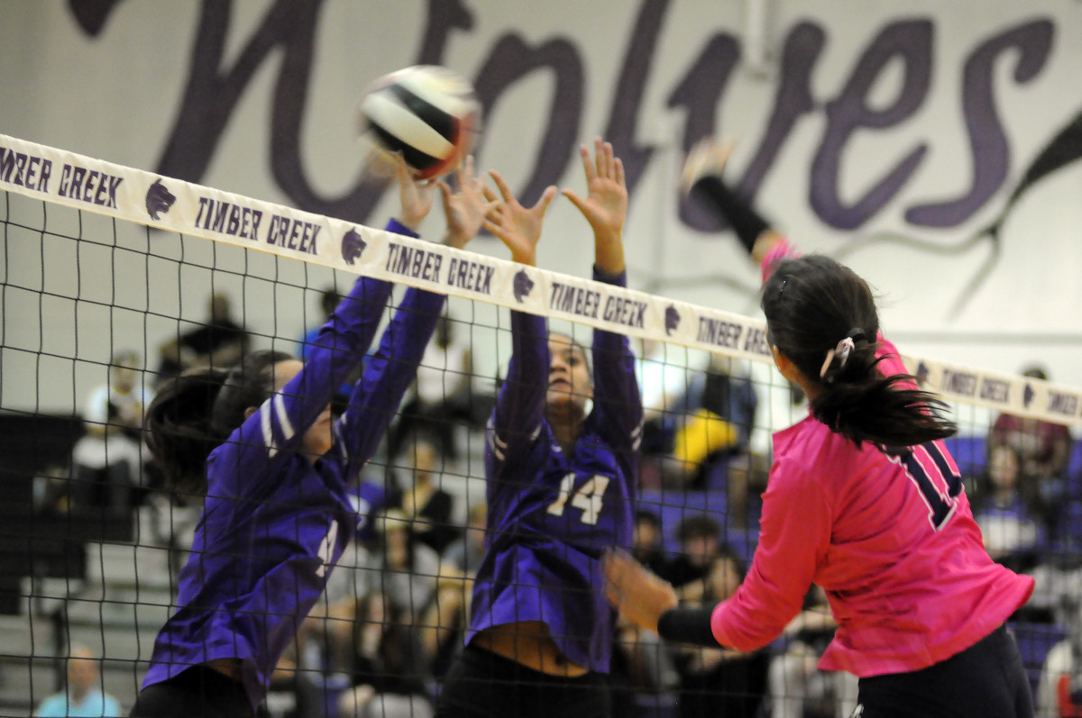 Timber Creek's Valerie Yambao (4) and Channing Warren (14) go for a block against Lane Nona's Emma Gongora during their match Wednesday. Yambao had 44 assists and Warren had seven kills and six blocks. Gongora had 19 kills.